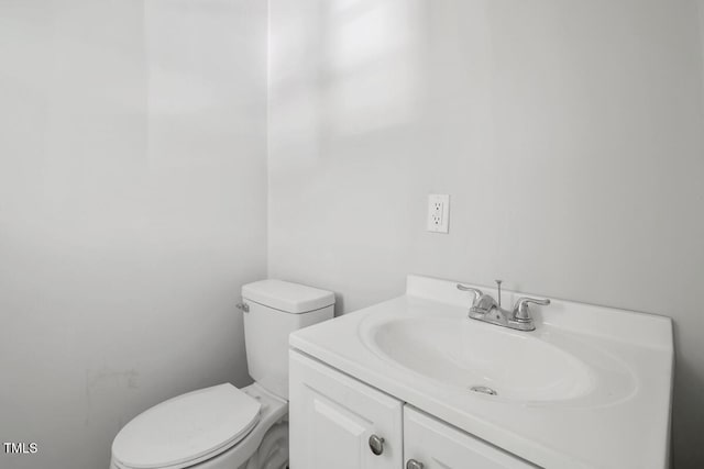 half bathroom featuring toilet and vanity