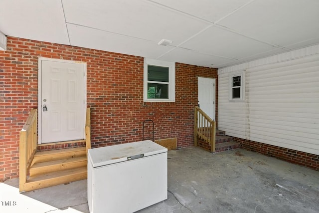 view of exterior entry with brick siding