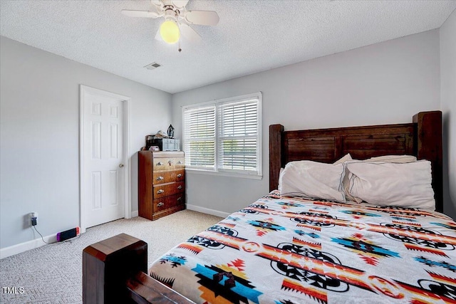 bedroom with baseboards, carpet flooring, ceiling fan, and a textured ceiling