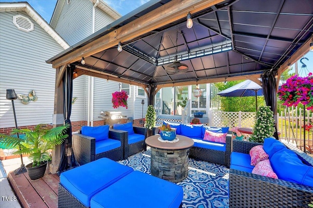 view of patio / terrace featuring a gazebo, an outdoor hangout area, and fence