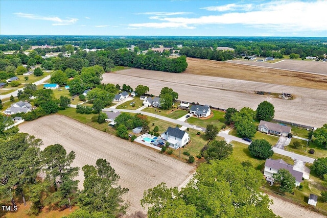 aerial perspective of suburban area featuring a tree filled landscape