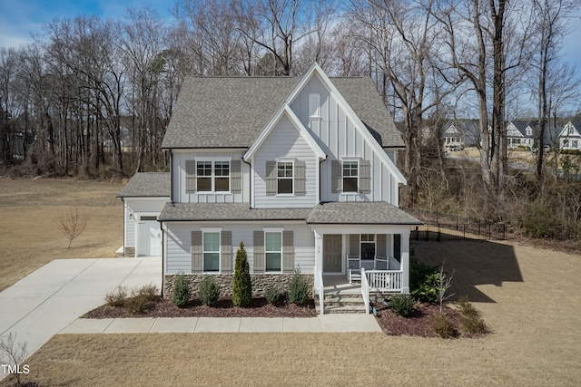 76 Freewill Pl, Raleigh, NC 27603 - view of front facade featuring covered porch, driveway, board and batten siding, roof with shingles, and an attached garage