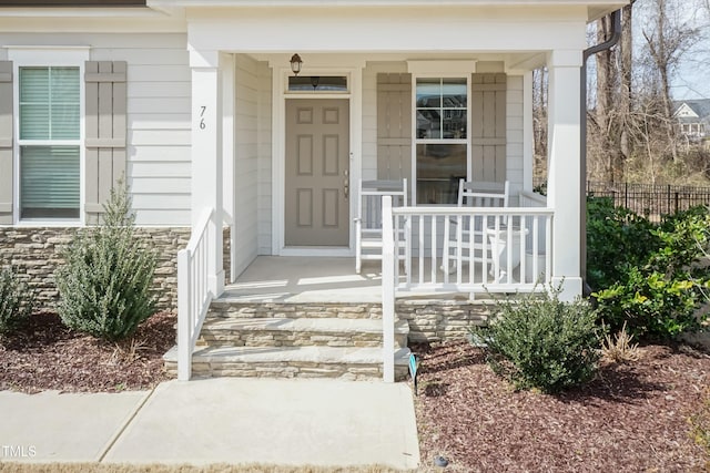 76 Freewill Pl, Raleigh, NC 27603 - view of exterior entry featuring a porch and stone siding