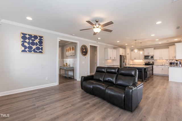 76 Freewill Pl, Raleigh, NC 27603 - living area with a ceiling fan, light wood-style floors, crown molding, recessed lighting, and baseboards