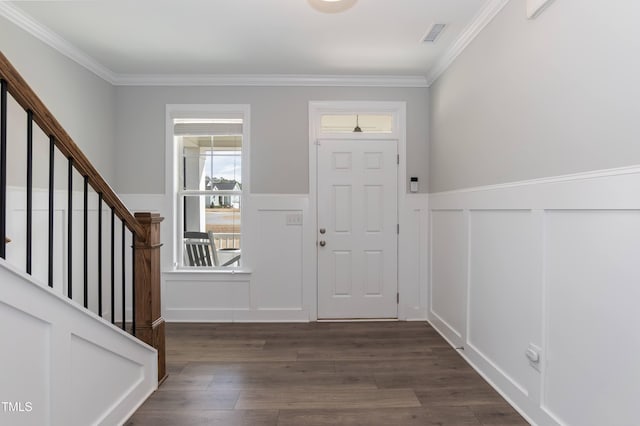 76 Freewill Pl, Raleigh, NC 27603 - foyer with a decorative wall, crown molding, dark wood finished floors, wainscoting, and stairs