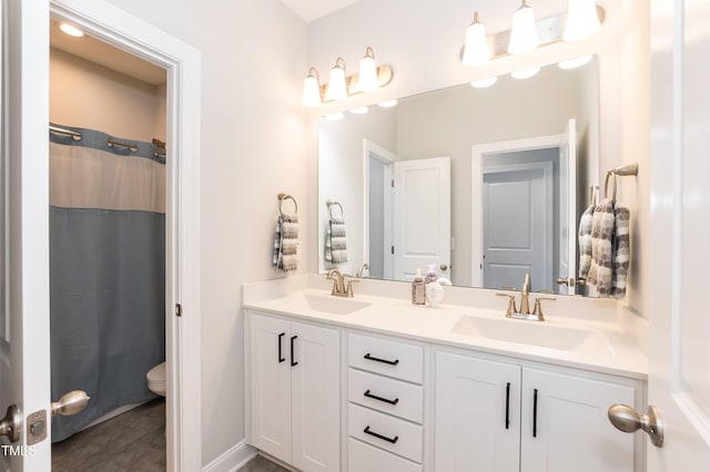 76 Freewill Pl, Raleigh, NC 27603 - bathroom with double vanity, toilet, and a shower with curtain