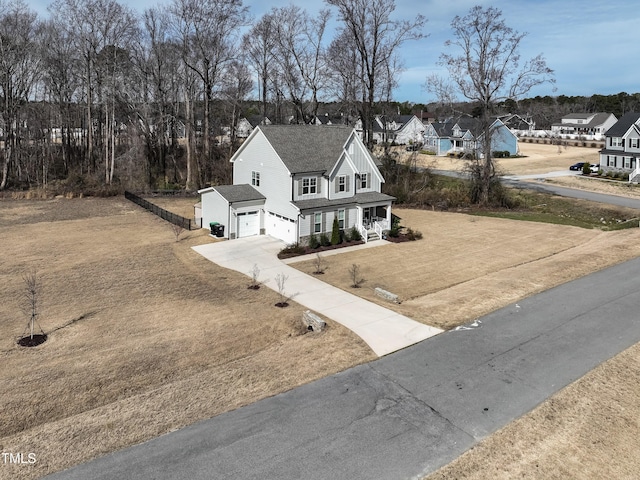 76 Freewill Pl, Raleigh, NC 27603 - view of home's exterior featuring a porch, concrete driveway, a garage, and a residential view