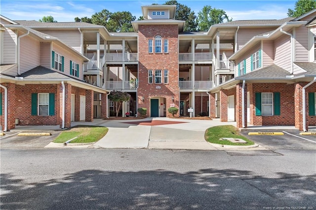 view of building exterior with uncovered parking