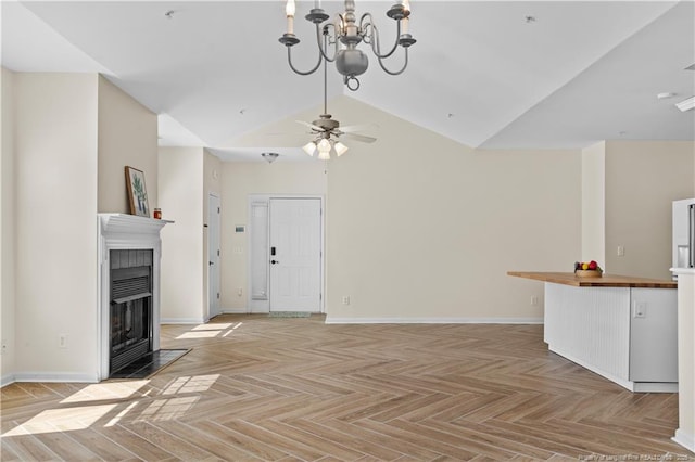 unfurnished living room featuring a fireplace with flush hearth, baseboards, ceiling fan, a chandelier, and high vaulted ceiling