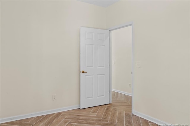 empty room featuring baseboards