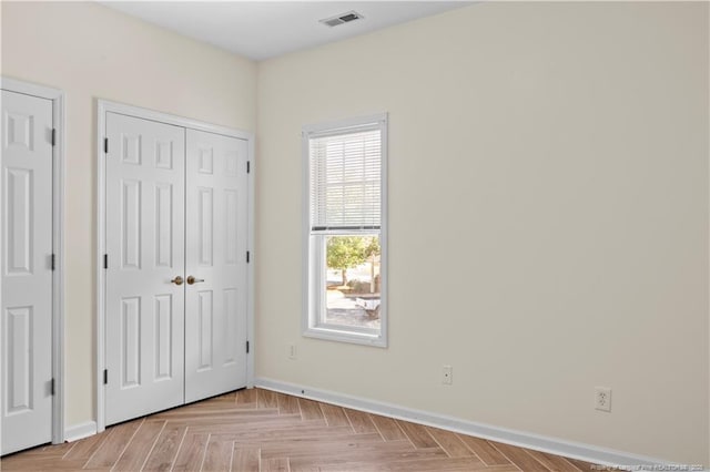 unfurnished bedroom with baseboards and a closet