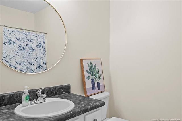 bathroom featuring vanity, toilet, and a shower with shower curtain