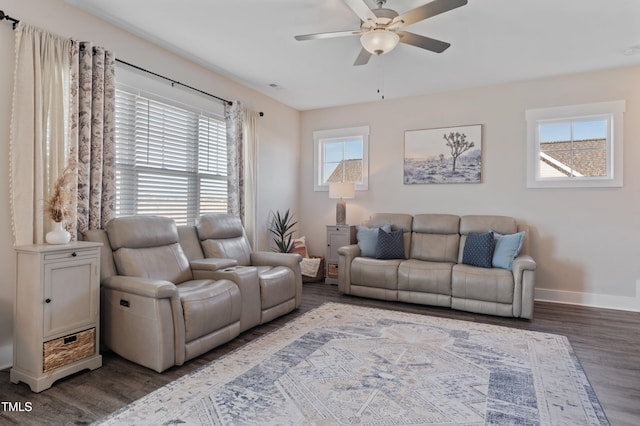 living room with a ceiling fan, dark wood-type flooring, and baseboards