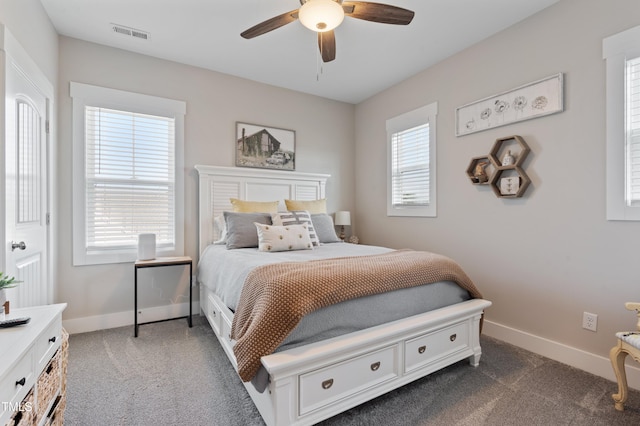 carpeted bedroom with baseboards and ceiling fan