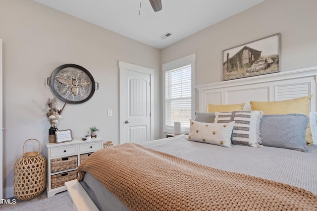 bedroom with a ceiling fan and carpet