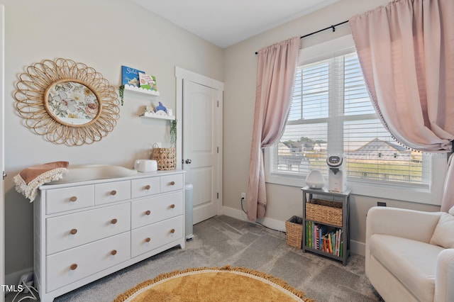living area featuring light colored carpet, healthy amount of natural light, and baseboards