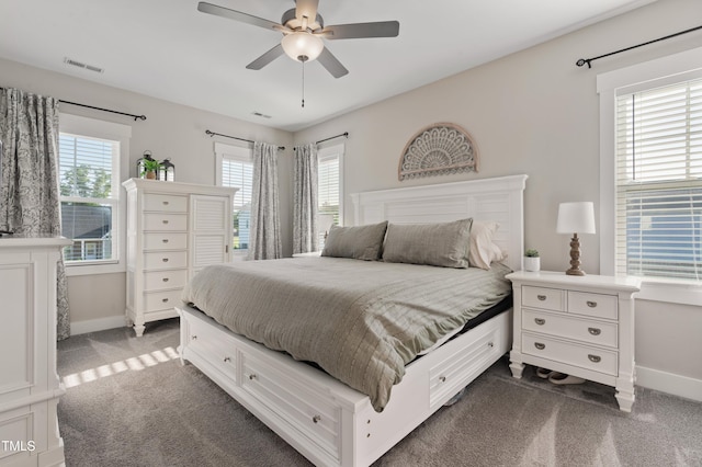 bedroom featuring dark carpet, baseboards, and a ceiling fan