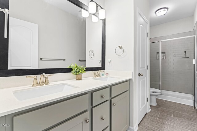 173 Longbow Dr, Middlesex, NC 27557 - bathroom with toilet, double vanity, and a stall shower