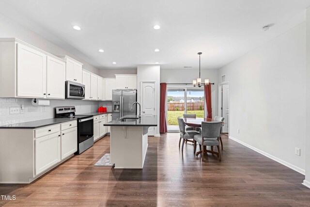 173 Longbow Dr, Middlesex, NC 27557 - kitchen with appliances with stainless steel finishes, dark countertops, a chandelier, baseboards, and white cabinets