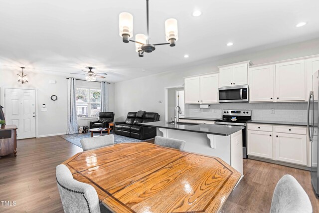 173 Longbow Dr, Middlesex, NC 27557 - dining space with a chandelier, a ceiling fan, wood finished floors, and recessed lighting