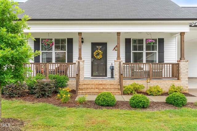 173 Longbow Dr, Middlesex, NC 27557 - view of front facade featuring a porch, roof with shingles, and a front yard