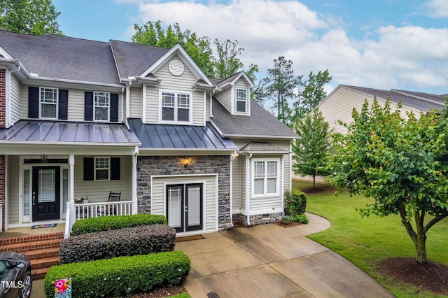 112 River Dell Townes Ave, Clayton, NC 27527 - view of front facade featuring a standing seam roof, french doors, a front lawn, a shingled roof, and a porch