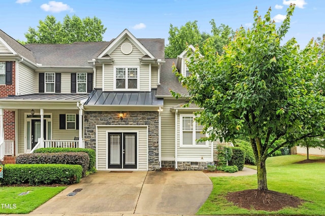 112 River Dell Townes Ave, Clayton, NC 27527 - view of front of house with a standing seam roof, a front yard, french doors, metal roof, and stone siding