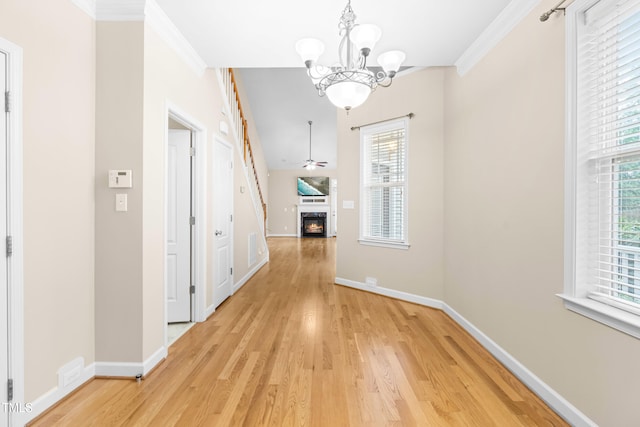 112 River Dell Townes Ave, Clayton, NC 27527 - hall featuring crown molding, light wood-type flooring, healthy amount of natural light, a chandelier, and baseboards
