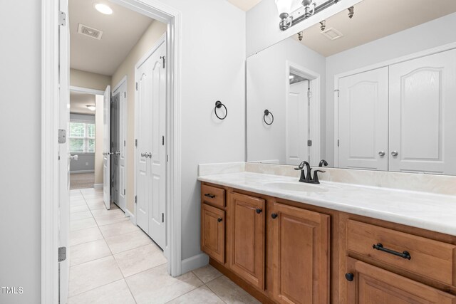 112 River Dell Townes Ave, Clayton, NC 27527 - bathroom featuring vanity, tile patterned floors, and baseboards