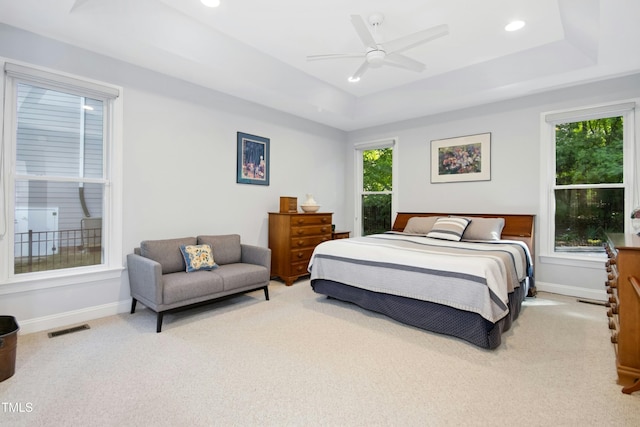 bedroom with carpet, a tray ceiling, baseboards, ceiling fan, and recessed lighting