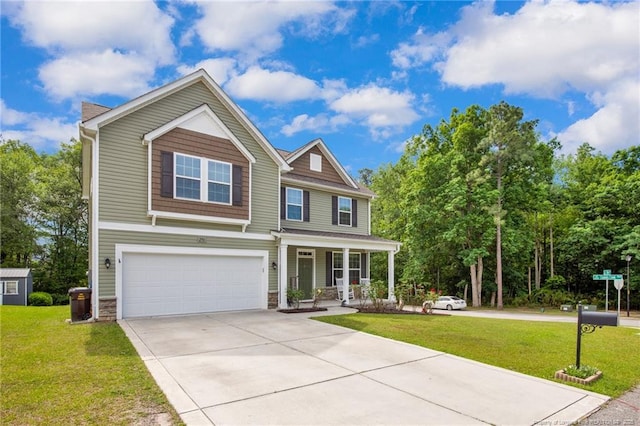 view of front of house featuring a porch, a garage, concrete driveway, and a front yard
