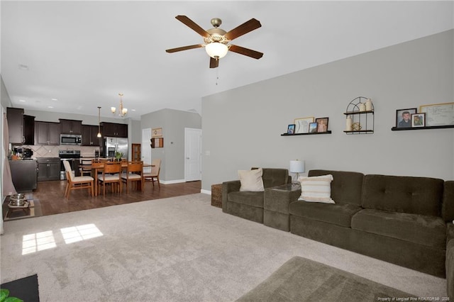 living area with dark colored carpet, a ceiling fan, baseboards, and recessed lighting