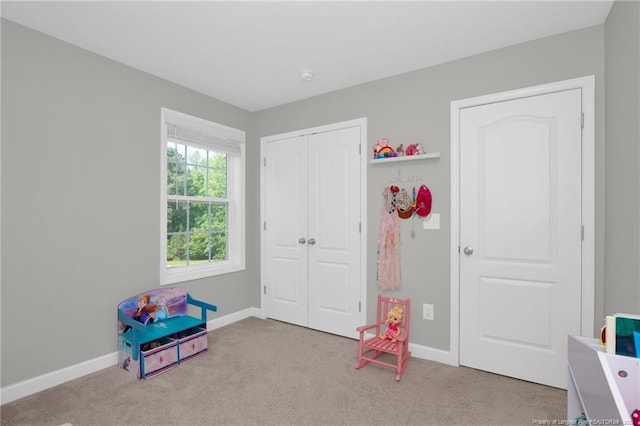 playroom with carpet floors and baseboards