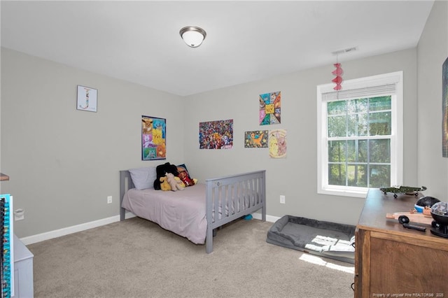 carpeted bedroom with baseboards