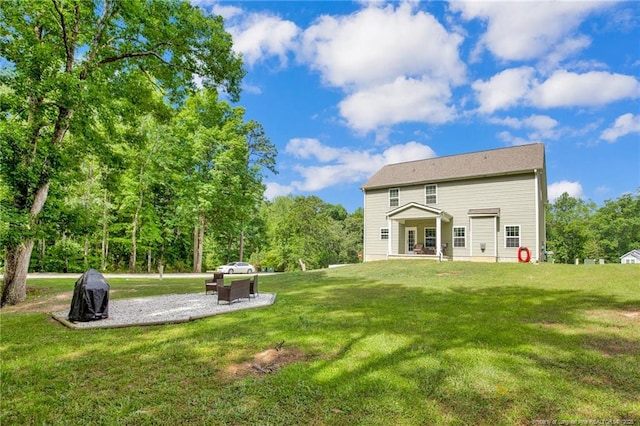 rear view of property with a lawn and a patio area