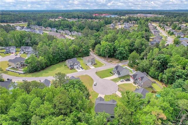 aerial view of residential area featuring a heavily wooded area