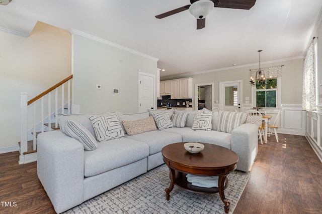 187 Ashley Woods Ct, Clayton, NC 27527 - living area featuring a chandelier, ceiling fan, wood finished floors, ornamental molding, and stairway