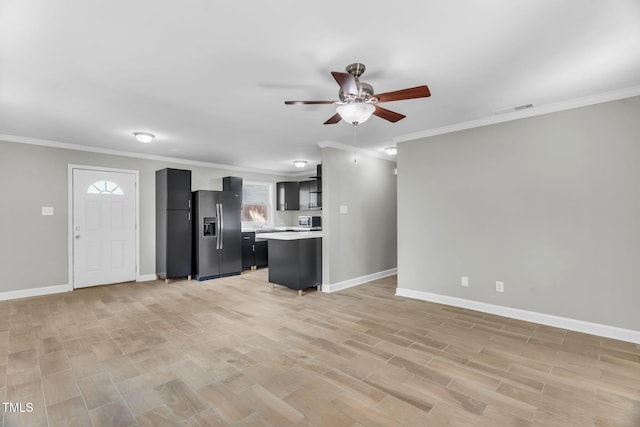 308 Lynn Rd, Durham, NC 27703 - unfurnished living room featuring ceiling fan, ornamental molding, light wood-style flooring, and baseboards
