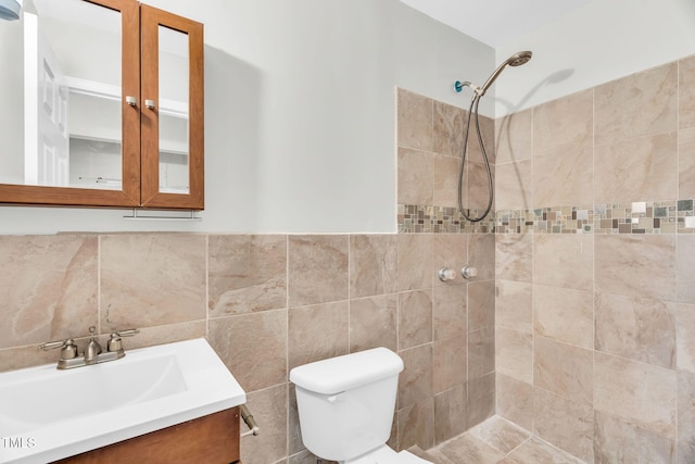 308 Lynn Rd, Durham, NC 27703 - bathroom with a tile shower, toilet, vanity, and tile walls