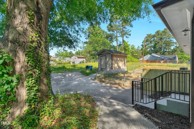 308 Lynn Rd, Durham, NC 27703 - exterior space with fence, a shed, and an outbuilding