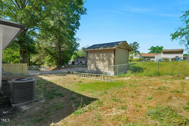 308 Lynn Rd, Durham, NC 27703 - view of yard featuring central AC, an outdoor structure, and a storage unit