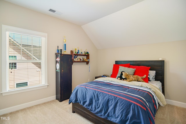 carpeted bedroom featuring lofted ceiling, multiple windows, and baseboards