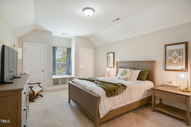 bedroom with light colored carpet, lofted ceiling, and baseboards