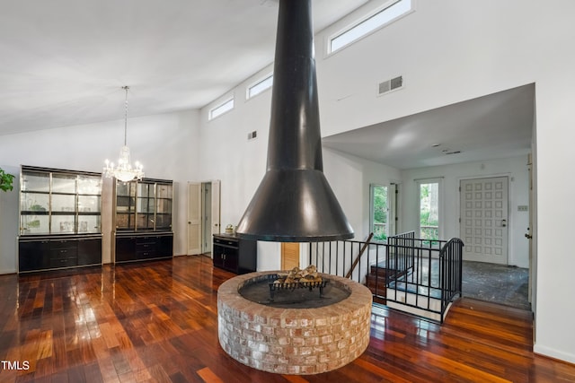 3416 Ocotea St, Raleigh, NC 27607 - living room with a high ceiling, hardwood / wood-style floors, healthy amount of natural light, and a chandelier