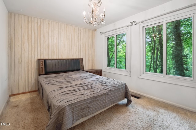3416 Ocotea St, Raleigh, NC 27607 - carpeted bedroom with a chandelier, wood walls, and baseboards
