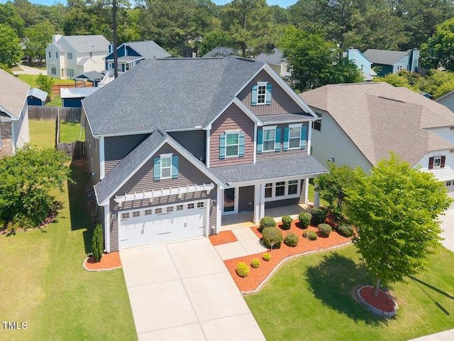 craftsman inspired home featuring concrete driveway, a shingled roof, and board and batten siding