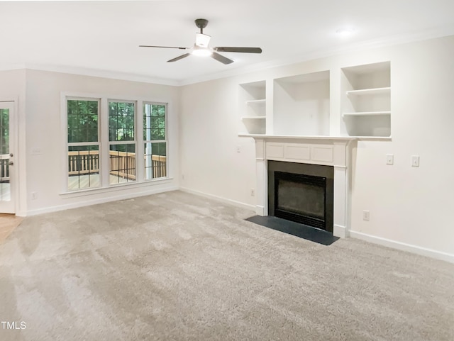 150 Remington Ct, Youngsville, NC 27596 - unfurnished living room with crown molding, baseboards, a ceiling fan, a fireplace with flush hearth, and carpet floors