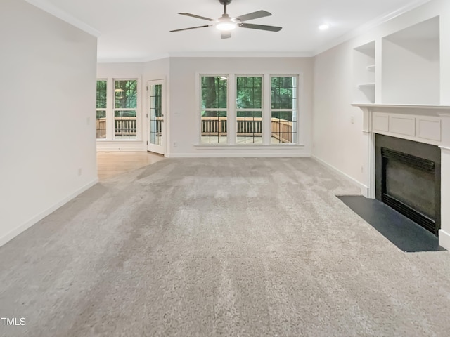 150 Remington Ct, Youngsville, NC 27596 - unfurnished living room featuring a fireplace with flush hearth, ornamental molding, ceiling fan, baseboards, and light carpet