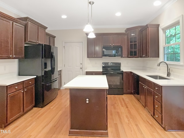 150 Remington Ct, Youngsville, NC 27596 - kitchen featuring black appliances, a sink, a center island, light wood finished floors, and crown molding