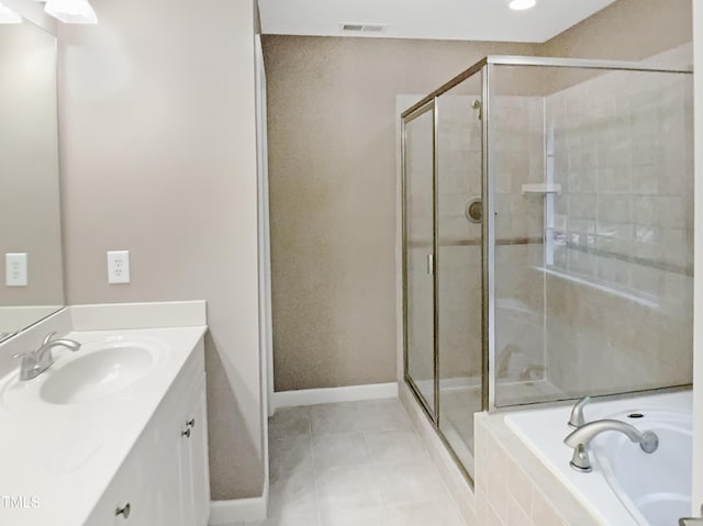 150 Remington Ct, Youngsville, NC 27596 - bathroom with a shower stall, vanity, tile patterned floors, and a garden tub